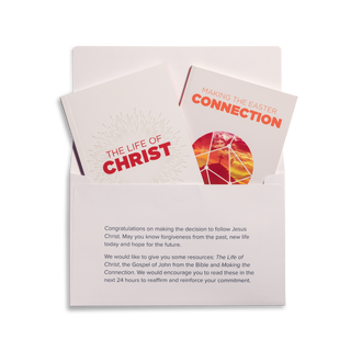 An open Easter Response Pack with its contents displayed, including The Life of Christ, Making the Easter Connection by J.John, and a response envelope.