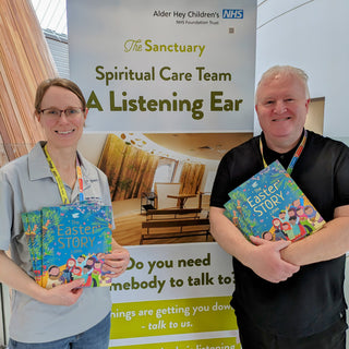 Two chaplains hold copies of J.John's book - The Easter Story - at a hospital where the books are being given out free to patients and their families.