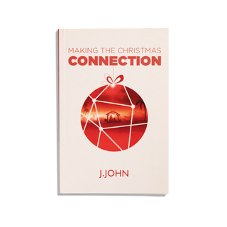A book cover with a title 'Making the Christmas Connection' by J.John, featuring a red ornament design with a nativity scene.