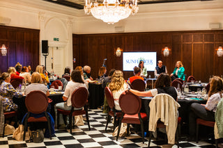 Delegates listen to J.John, Killy John and Carrie Headington at the Sunflower Collective